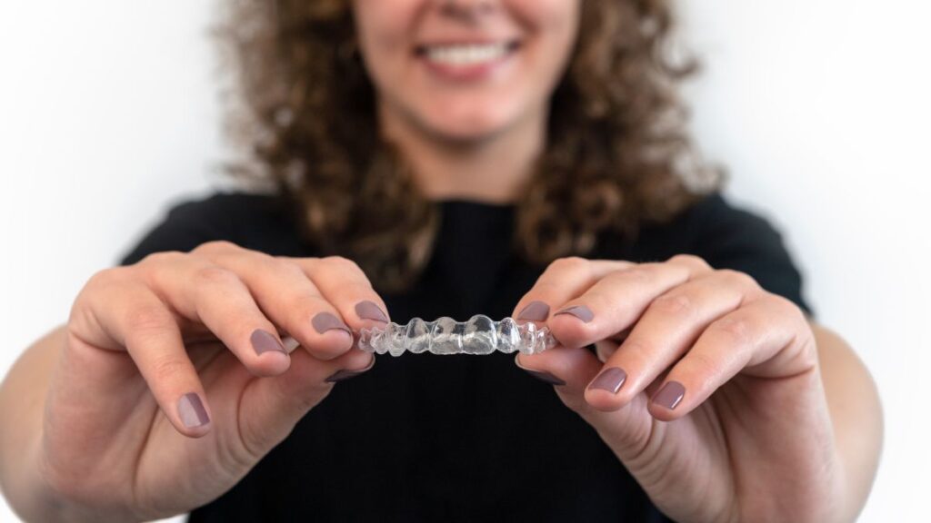 caucasian-young-woman-showing-invisible-silicone-a-2024-12-07-12-52-56-utc - Exceptional Dentistry Clear Alingers
